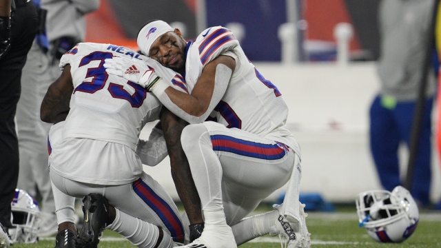 Buffalo Bills' Siran Neal and Nyheim Hines react after teammate Damar Hamlin was injured.