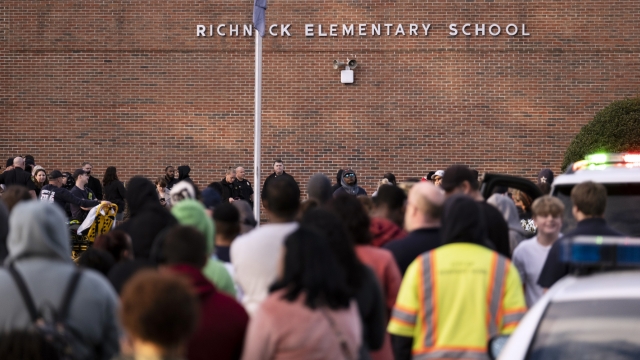 Students and police gather outside of Richneck Elementary School after a shooting