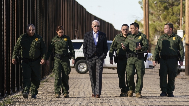 President Joe Biden walking with Border Security guards.