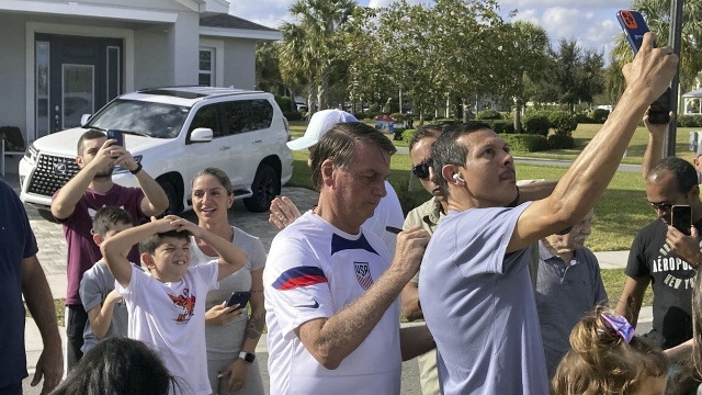 Jair Bolsonaro, Brazil's former president, meets with supporters outside a vacation home in Florida.