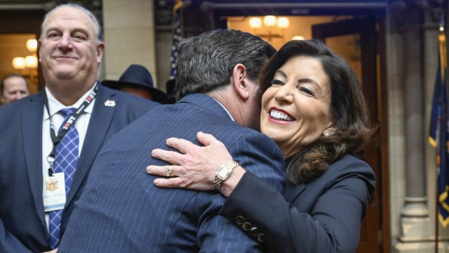 New York Gov. Kathy Hochul, right, gets a hug as she arrives to deliver her State of the State address
