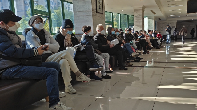 Family members of the deceased wait for the cremation procedures at a funeral home in Shanghai, China.