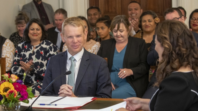 Chris Hipkins, center left, is sworn in as New Zealand's next prime minister by Governor-General Dame Cindy Kiro, right