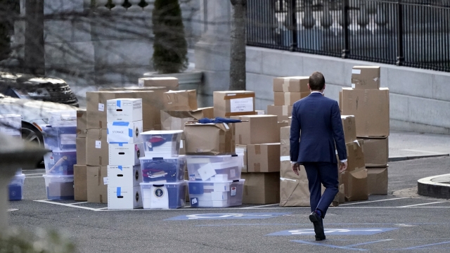 A man walks past boxes that were moved out of the Eisenhower Executive Office building inside the White House complex.