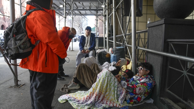 Migrants camp on the New York City sidewalk.