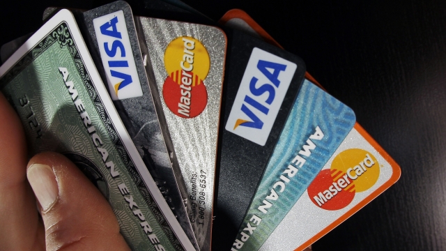 Person holding a stack of credit cards.