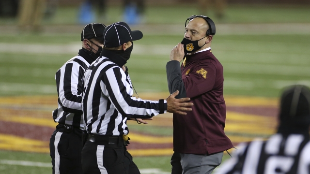 Minnesota head coach P.J. Fleck settles with referres during the first half of an NCAA college football game against Iowa