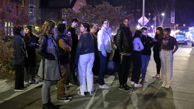 Students gather on the campus of Michigan State University after a shelter in place order was lifted