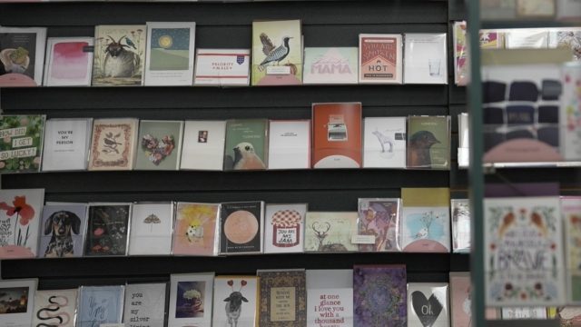 Valentine's Day cards sit lined up on shelves