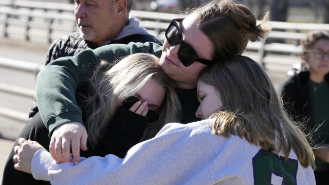 Michigan State University students embrace at The Rock on campus