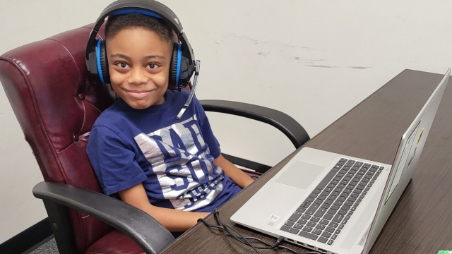 9-year-old David Balogun sits in front of a laptop