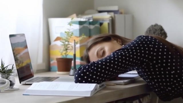 Woman sleeping on her desk