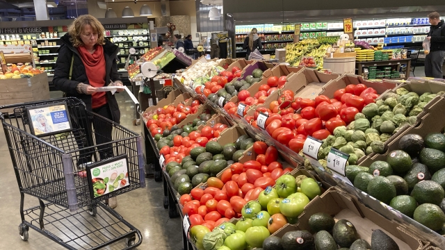 Shoppers pick out items at a grocery store in Glenview, Ill.
