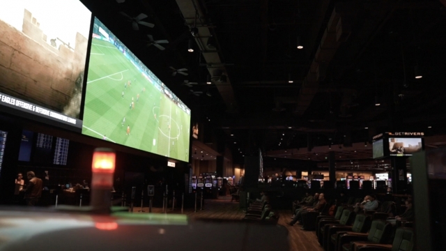 A soccer game is displayed on a screen.