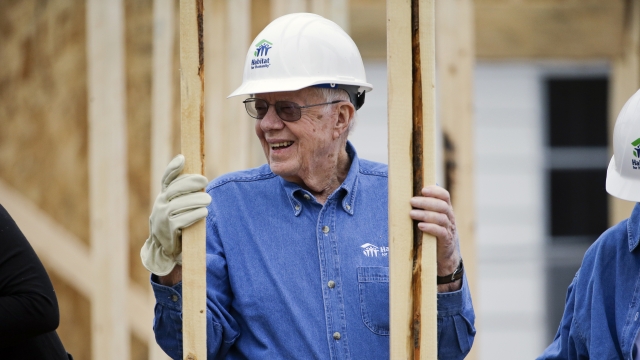 Former President Jimmy Carter works at a Habitat for Humanity building site.