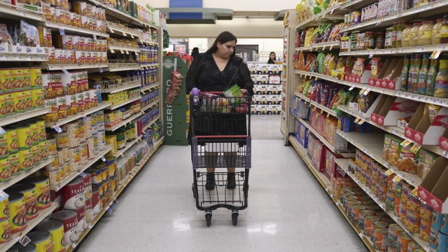 Jacqueline Benitez pushes her cart down an aisle at a grocery store.