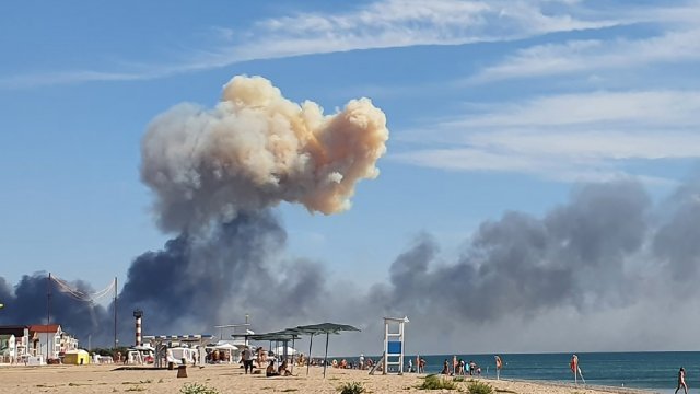FILE - Rising smoke can be seen from the beach at Saky