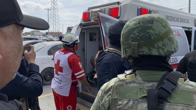 A Red Cross worker closes the door of an ambulance carrying two Americans found alive after their abduction in Mexico
