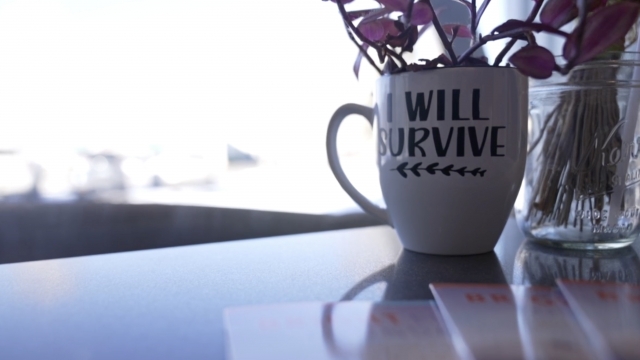 A mug with text saying "I will survive"