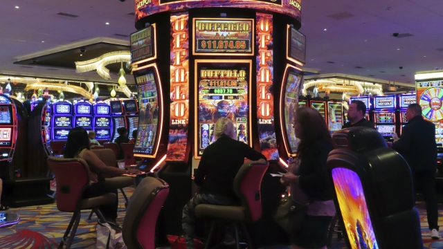 Gamblers play slot machines at a Hard Rock casino