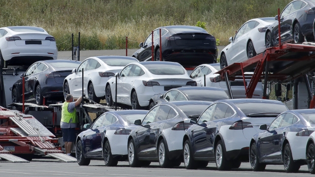 Tesla cars are loaded onto carriers at the Tesla electric car plant