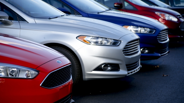 A row of new Ford Fusions are for sale on a car lot.
