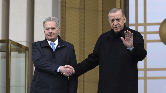 Turkish President Recep Tayyip Erdogan, right, and Finland's President Sauli Niinisto shake hands