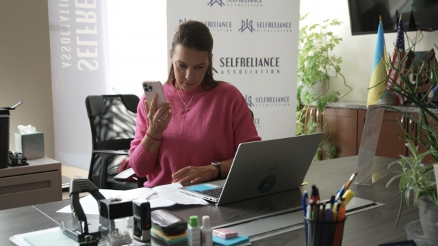 Natalya Zavizistup sits at her desk.