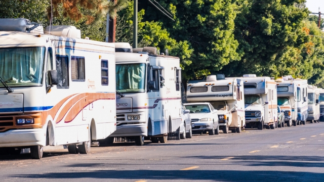 Line of RVs parked along a road.