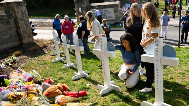 Three girls pay respects at a growing memorial for the victims of Monday's school shooting in Nashville.