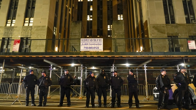 Law enforcement officers stand outside a courthouse in New York