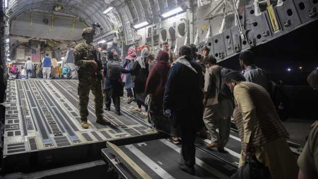 Afghan passengers board a U.S. Air Force C-17 Globemaster III during the Afghanistan evacuation.