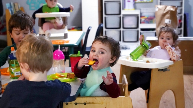 Preschoolers eat lunch at a day care center