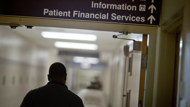 A sign points visitors toward the financial services department at a hospital