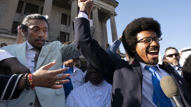 Tennessee Rep. Justin Jones, D-Nashville (left), and Rep. Justin Pearson, D-Memphis (right), raise their hands