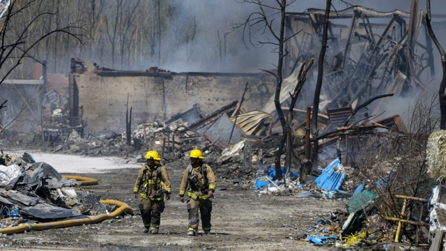 Firefighters walk out of the site of an industrial fire in Richmond, Indiana.