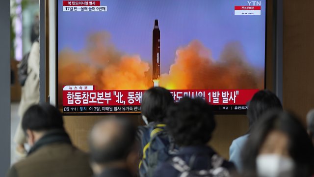 TV screen broadcasts a North Korean missile launch.