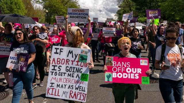 Protesters march past U.S. Capitol following a Planned Parenthood rally in support of abortion access outside Supreme Court.