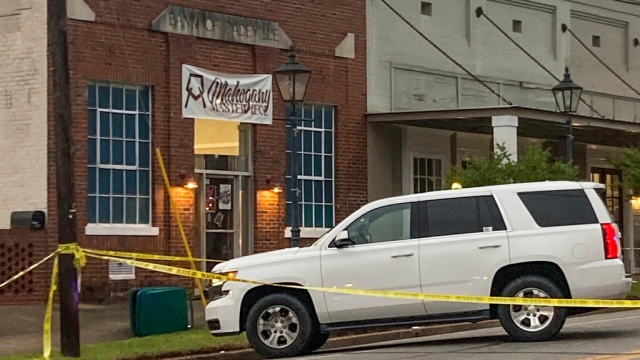 Investigators work at the site of a fatal shooting in downtown Dadeville, Alabama.