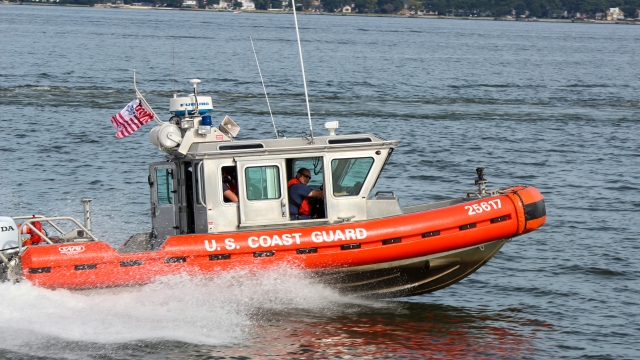 A U.S. Coast Guard boat is shown.