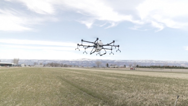 A drone flies over a field
