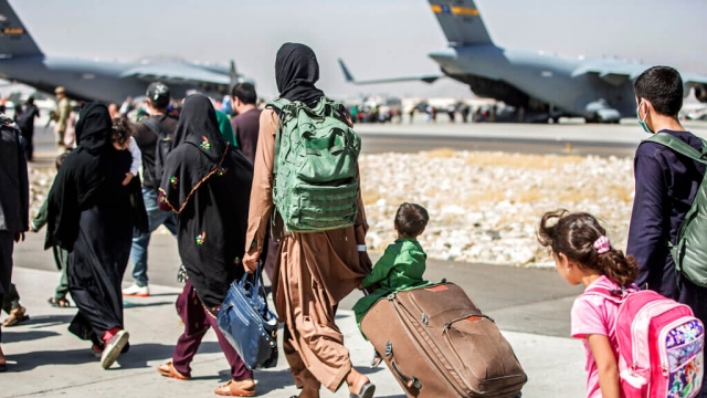 Families walk towards their flight during the U.S. evacuation of Afghanistan on Aug. 24, 2021.