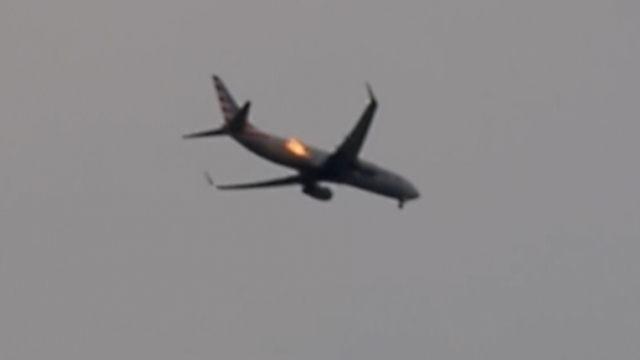 Flames coming from the engine of an American Airlines flight