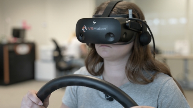 A student with autism practices driving with a virtual reality headset.
