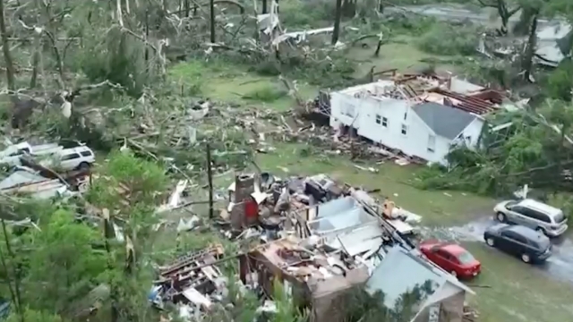 Homes hit by a storm are shown.