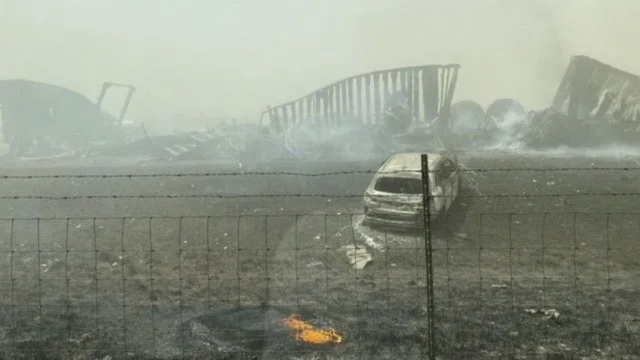 Smoldering wreckage is seen after a crash on I-55.