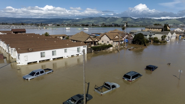 Floodwaters surround homes and vehicles in the community of Pajaro in Monterey County, California.