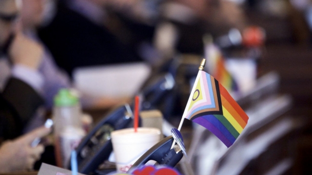 A flag supporting LGBTQ+ rights sits on a desk on the Democratic side of the Kansas House of Representatives during a debate.