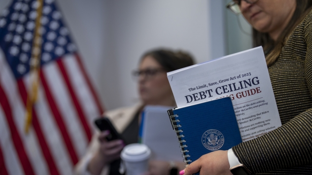 A staffer with the Republican leadership holds a guide to Speaker Kevin McCarthy's debt ceiling package.