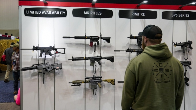 A guest browses firearms in the Heckler & Koch display at the National Rifle Association's Annual Meetings & Exhibits